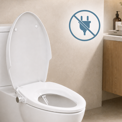 A white toilet and bidet seat with the lid open in a bathroom setting, featuring a blue wall decal showing a crossed-out electrical plug symbol.