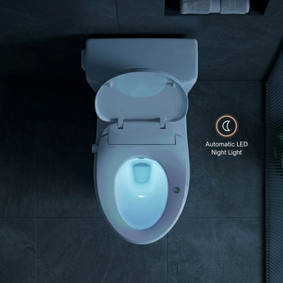 Top-down view of a white toilet with the lid open, showing a glowing blue LED light inside the bowl. The scene is set in a dark gray tiled bathroom, with an overlay reading 'Automatic LED Night Light' and a moon icon.