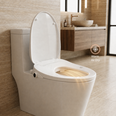 A white bidet seat with the lid open, shown in a modern bathroom setting with a warm light glowing from the seat area. A circular graphic overlay reads 'Warm Air Dry' with a fan icon, indicating the air-dry function.